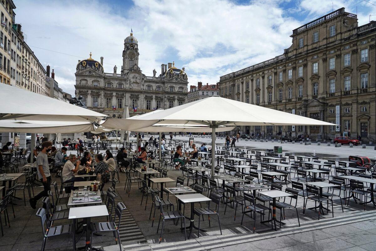 People eat and drink outdoors at a terrace bar in Lyon, central France, on July 13, 2021. (Laurent Cipriani/AP Photo)