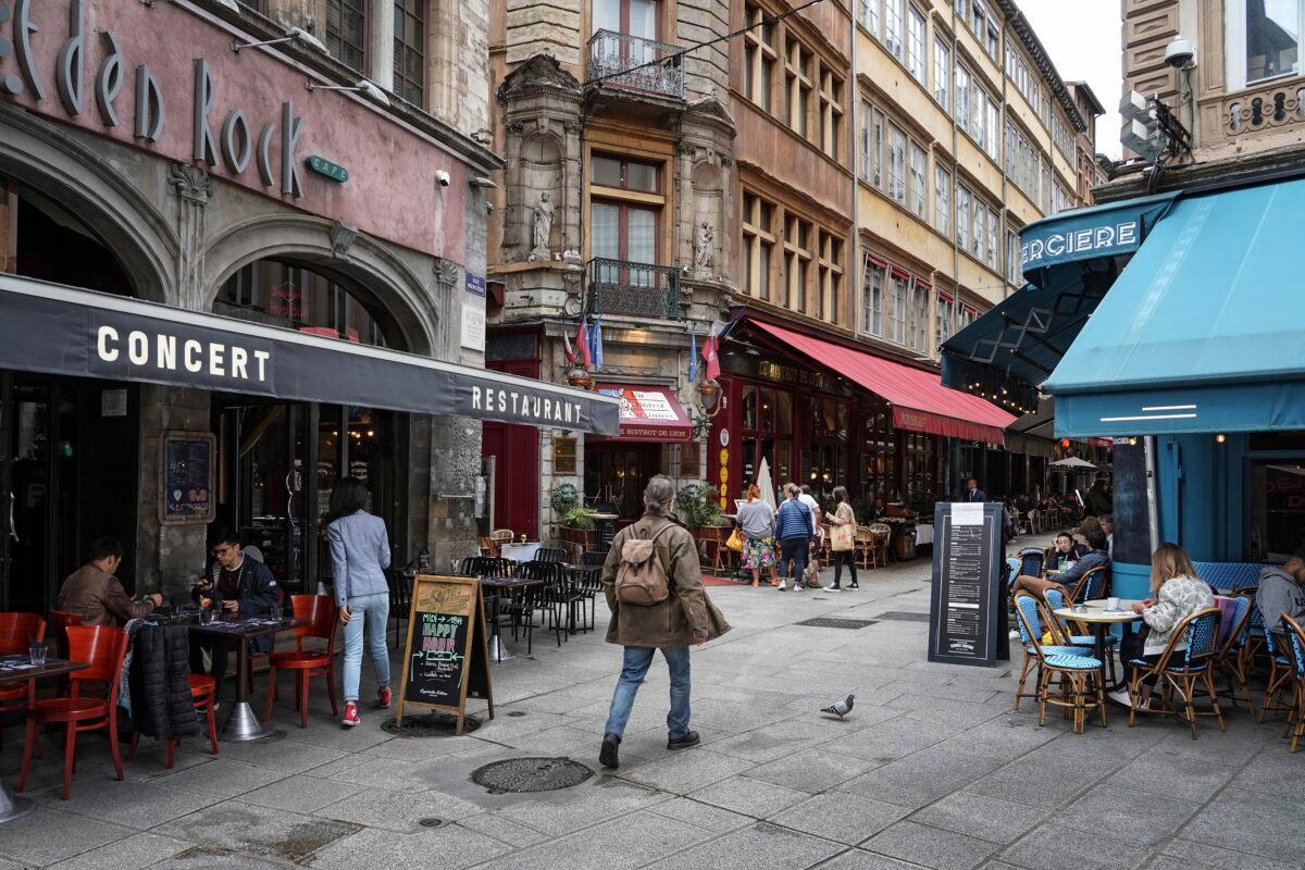 A man walks by restaurants in Lyon, central France, on July 13, 2021. (Laurent Cipriani/AP Photo)