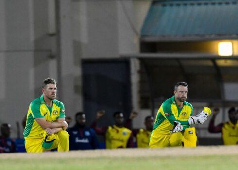 Aaron Finch (L) and Matthew Wade (R) of Australia kneel for Black Lives Matter during the 2nd T20I between Australia and West Indies at Darren Sammy Cricket Ground, Gros Islet, Saint Lucia, on July 10, 2021. (Randy Brooks/AFP via Getty Images)