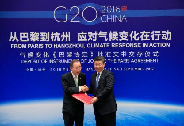 Chinese leader Xi Jinping (R) shakes hands with U.N. Secretary General Ban Ki-Moon during a joint ratification of the Paris climate change agreement with U.S. President Barack Obama (not pictured) ahead of the G20 Summit at the West Lake State Guest House in Hangzhou, China, on Sept. 3, 2016. (How Hwee Young/AFP via Getty Images)