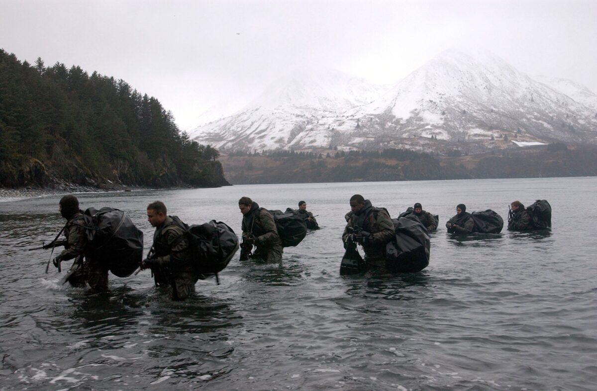 Navy SEALs perform Advanced Cold Weather training to experience the physical stress of the environment and how their equipment will operate, or even sound, in adverse conditions in Kodiak, Alaska, on Dec. 14, 2003. (Photo by Photographer's Mate 2nd Class Eric S. Logsdon/U.S. Navy via Getty Images)