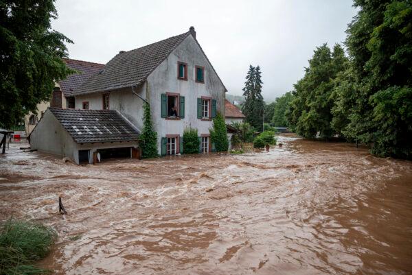 Houses are submerged on the overflowed river banks in Erdorf, Germany, July 15, 2021. (Harald Tittel/dpa via AP)