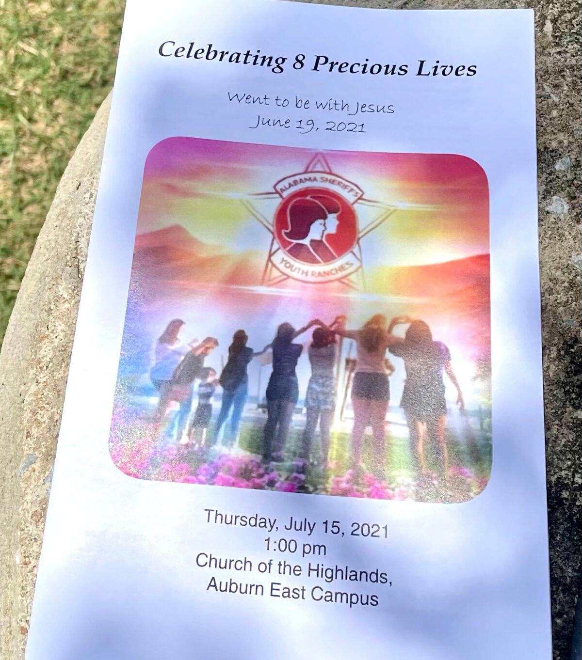 The program for a memorial service for eight young people, killed when a van returning to an Alabama girls' home after a week at the beach wrecked last month, is shown outside the event in Auburn, Ala. on July 15, 2021. (Kim Chandler/AP Photo)
