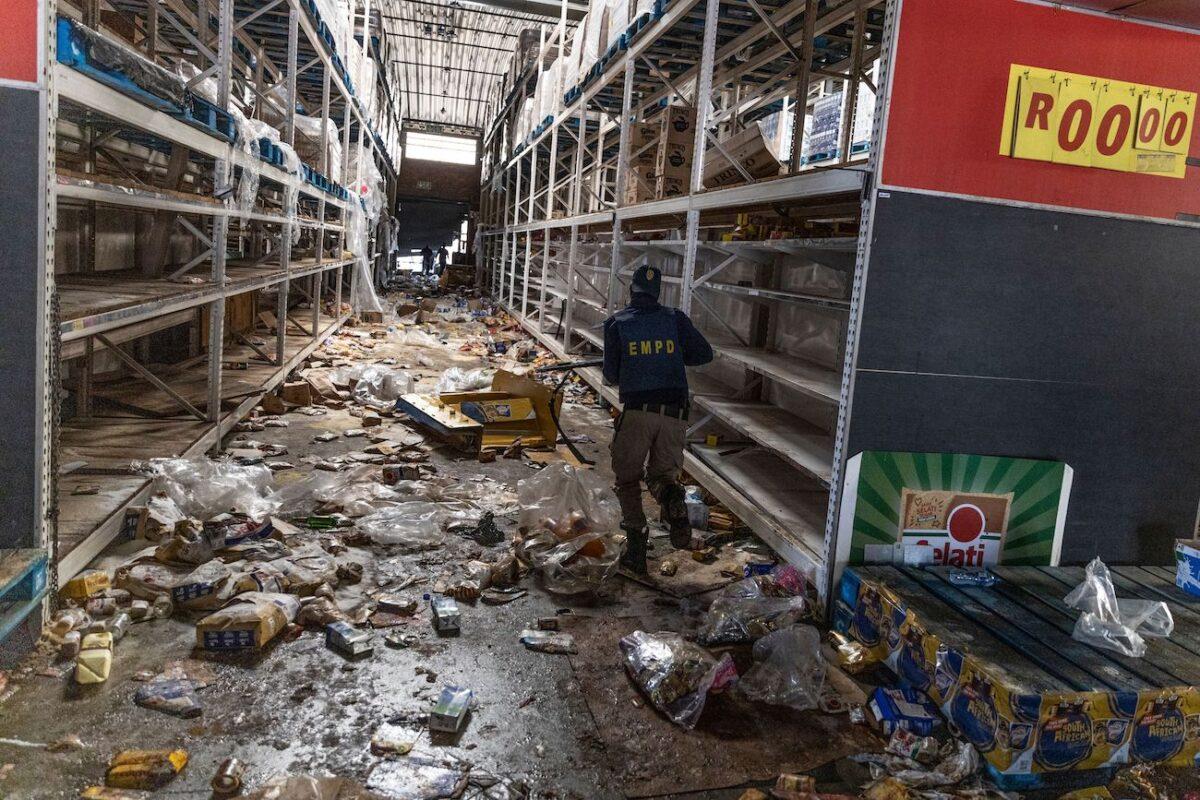 A member of the South African Police Services searches for looters inside the Gold Spot Shopping Center in Vosloorus, southeast of Johannesburg, on July 12, 2021. (Guillem Sartorio/AFP via Getty Images)