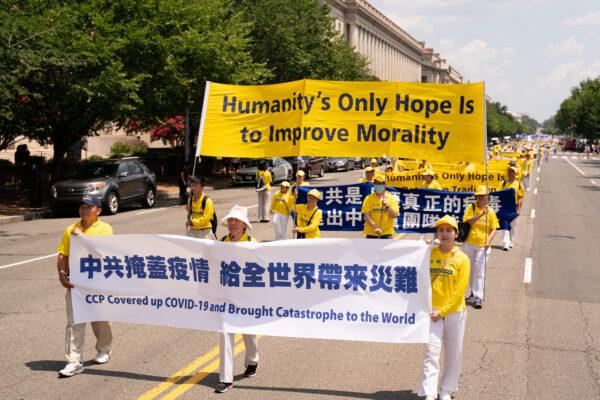 Falun Gong practitioners take part in a parade marking the 22nd anniversary of the start of the Chinese regime's persecution of Falun Gong, in Washington on July 16, 2021. (Larry Dye/The Epoch Times)