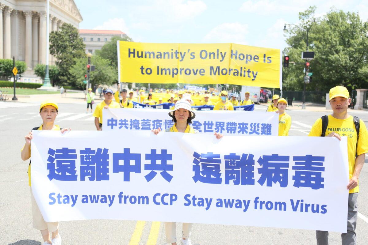 Falun Gong practitioners take part in a parade marking the 22nd anniversary of the start of the Chinese regime's persecution of Falun Gong, in Washington on July 16, 2021. (Lisa Fan/The Epoch Times)