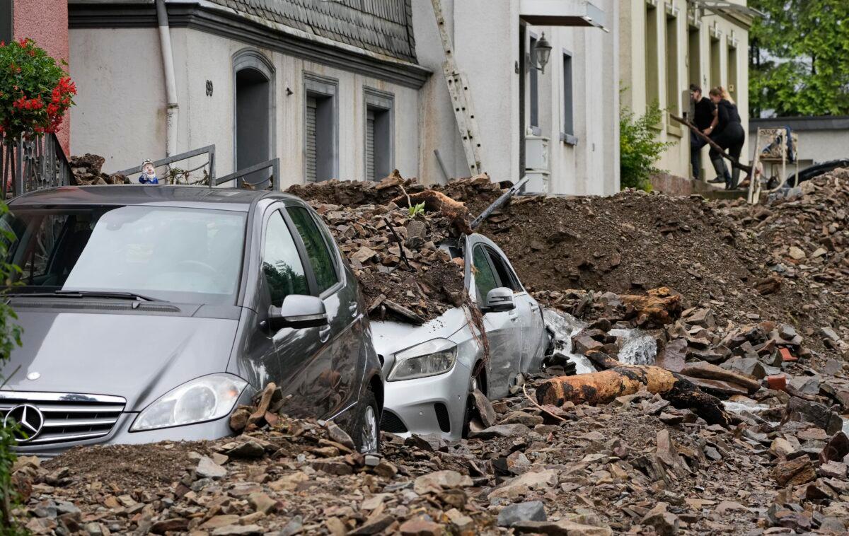 Cars are covered with the debris brought by the flooding of the 'Nahma' river the night before, in Hagen, Germany, on July 15, 2021. (Martin Meissner/AP Photo)