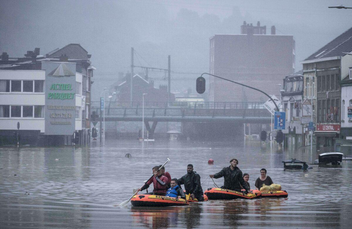 People use rubber rafts in floodwaters after the Meuse River broke its banks during heavy flooding in Liege, Belgium, on July 15, 2021. (Valentin Bianchi/AP Photo)