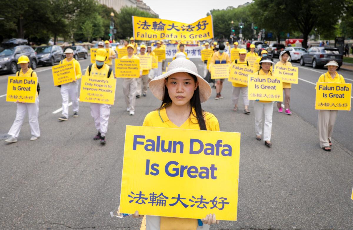 Falun Gong practitioners take part in a parade marking the 22nd anniversary of the start of the Chinese regime's persecution of Falun Gong, in Washington on July 16, 2021. (Samira Bouaou/The Epoch Times)