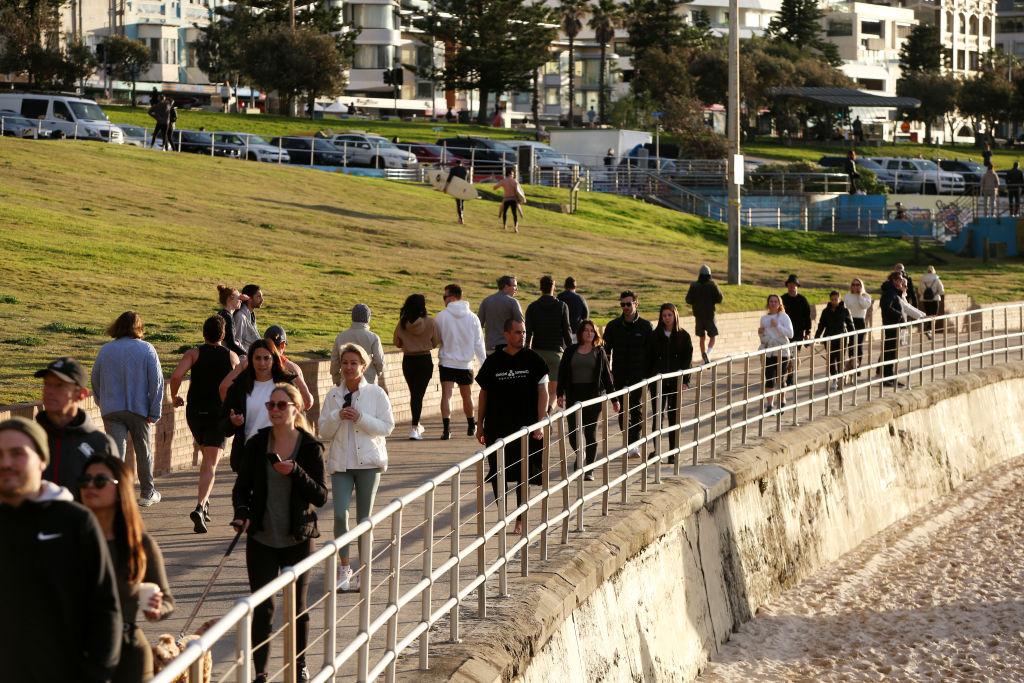 People are seen walking along the Bondi Beach boardwalk in Sydney, Australia, on July 14, 2021. (Lisa Maree Williams/Getty Images)