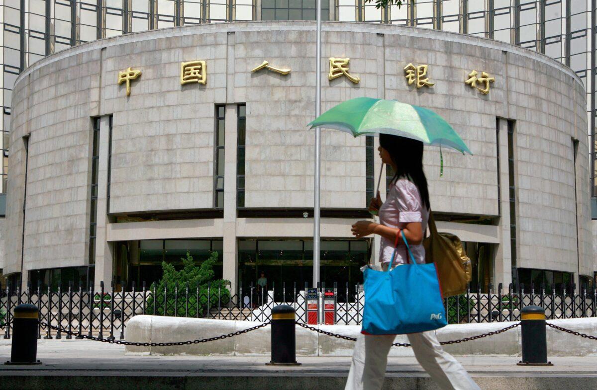 A pedestrian walks past the People's Bank of China, China's central bank, in Beijing in this undated photo. (Teh Eng Koon/AFP via Getty Images)