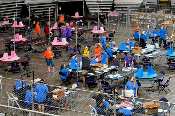 Maricopa County ballots cast in the 2020 general election are examined and recounted by contractors working for Florida-based company, Cyber Ninjas at Veterans Memorial Coliseum in Phoenix on May 6, 2021. (AP Photo/Matt York, Pool)