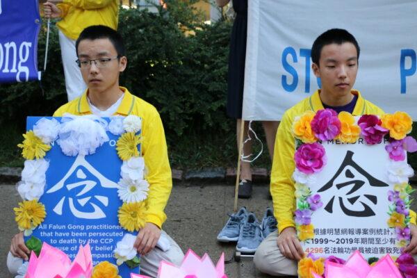 Brothers Jerry Yan (L) and Peter Yan attend a vigil in front of the Chinese Consulate in Toronto on July 15, 2021, memorializing the Falun Gong practitioners persecuted to death by the communist regime since 1999 and calling for an end to the persecution in China. (Andrew Chen/The Epoch Times)