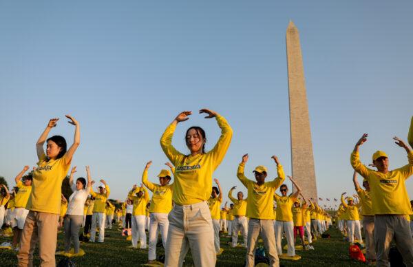 Falun Gong practitioners do exercises at an event marking the 22nd anniversary of the start of the Chinese regime’s persecution of Falun Gong, in Washington on July 16, 2021. (Samira Bouaou/The Epoch Times)