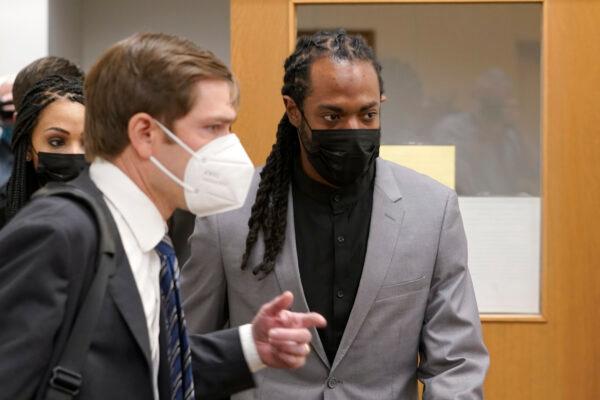 NFL football player Richard Sherman (R) heads into a hearing at King County District Court with his attorney Cooper Offenbecher, in Seattle, Wash., on July 16, 2021. (Ted S. Warren/AP Photo)