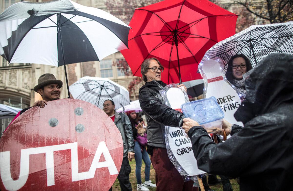Teachers, students, friends and family protest and picket in the rain outside John Marshall High School during a United Teachers Los Angeles strike in Los Angeles, Calif., on Jan. 14, 2019. (Barbara Davidson/Getty Images)