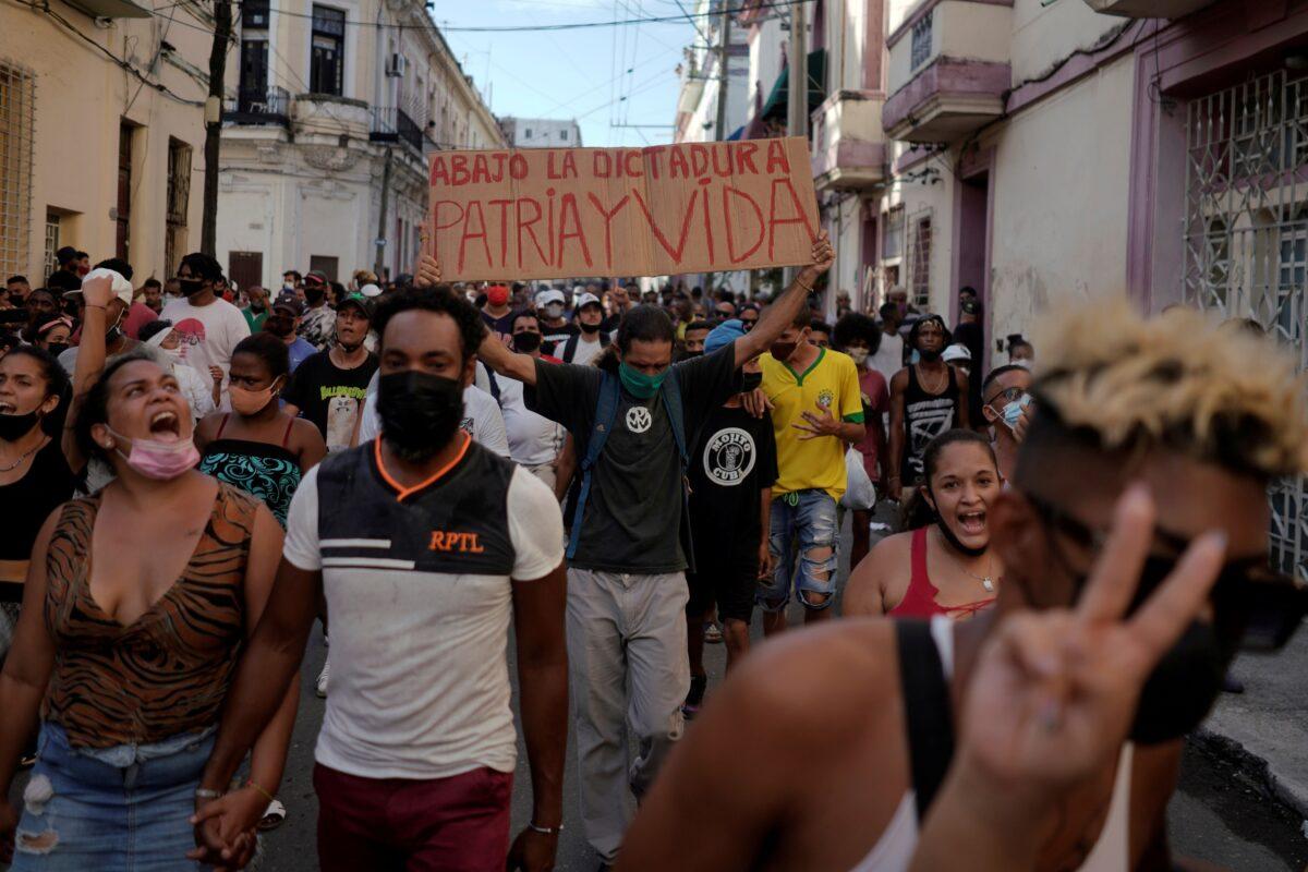 People shout slogans against the government during a protest in Havana, on July 11, 2021. (Alexandre Meneghini/Reuters)