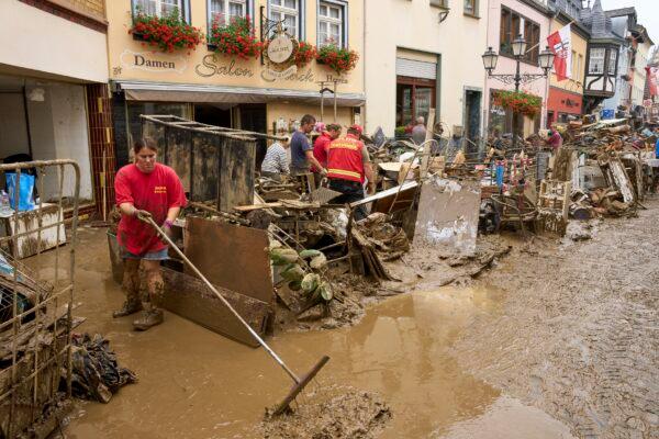 Residents and shopkeepers are trying to clear mud from their homes and move unusable furniture outside in Ahrweiler, western Germany, on  July 17, 2021. (Thomas Frey/dpa via AP)