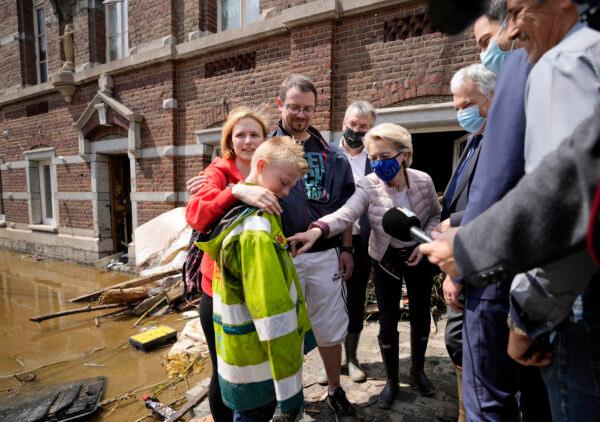 European Commission President Ursula von der Leyen (C) speaks with Madeline Brasseur, 37, Paul Brasseur, 42, and their son Samuel, 12 as she tours the village after flooding in Pepinster, Belgium, on July 17, 2021. (Virginia Mayo/AP Photo)