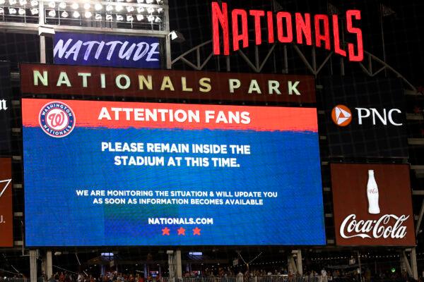 The scoreboard displays a message to fans during a stoppage in play due to an incident near the ballpark in the sixth inning of a baseball game between the Washington Nationals and the San Diego Padres, in Washington, on July 17, 2021. (Nick Wass/AP Photo)