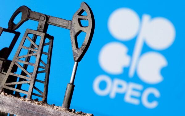 A 3D printed oil pump jack is seen in front of displayed OPEC logo in this illustration picture on April 14, 2020. (Dado Ruvic/Illustration/Reuters)