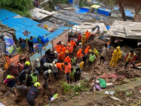 Rescuers look for survivors after a wall collapsed on several slum houses heavy monsoon rains in the Mahul area of Mumbai, India, on July 18, 2021. (Rajanish Kakade/AP Photo)