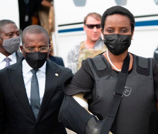 Haiti's First Lady Martine Moise, wearing a bullet proof vest and her right arm in a sling, arrives at the Toussaint Louverture International Airport, in Port-au-Prince, Haiti, on July 17, 2021. (Haiti's Secretary of State for Communication Photo/via AP)
