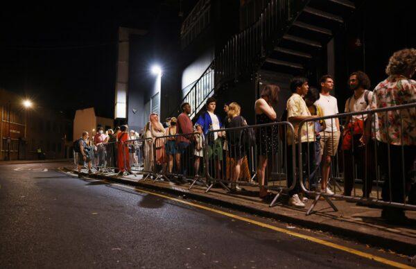 People arrive for the "00:01" event organised by Egyptian Elbows at Oval Space nightclub, as England lifted most COVID-19 restrictions at midnight, in London, early July 19, 2021. (Natalie Thomas/Reuters)