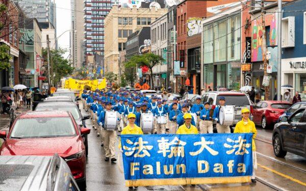 Falun Gong adherents march in downtown Toronto on July 17, 2021. (Evan Ning/The Epoch Times)