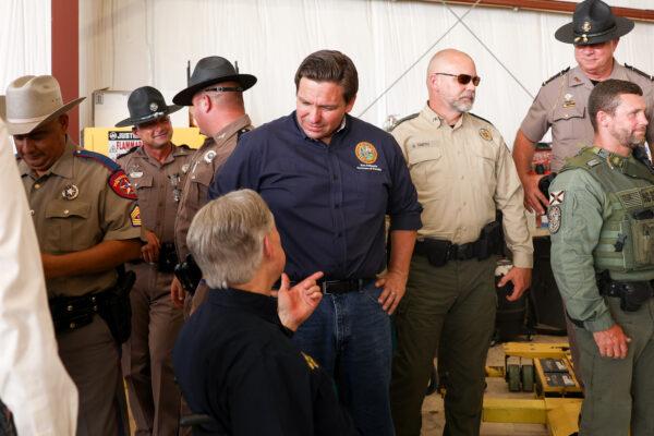 Florida Gov. Ron DeSantis speaks with Texas Gov. Greg Abbott at a border meeting in Del Rio, Texas, on July 18, 2021. (Charlotte Cuthbertson/The Epoch Times)