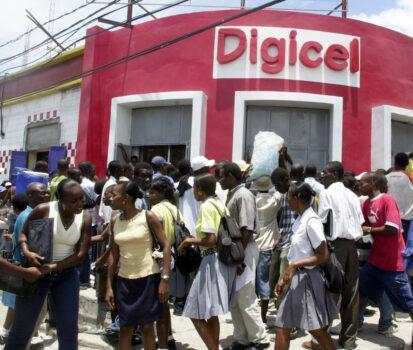 Haitians line up on May 5, 2006, at the DIGICEL office in Port-au-Prince to get new cellular phones and services. (Thony Belizaire/AFP via Getty Images)