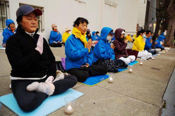 Practitioners hold a candlelight vigil in front of the Chinese Consulate in San Francisco on July 18, 2021. (Gary Wang/The Epoch Times)