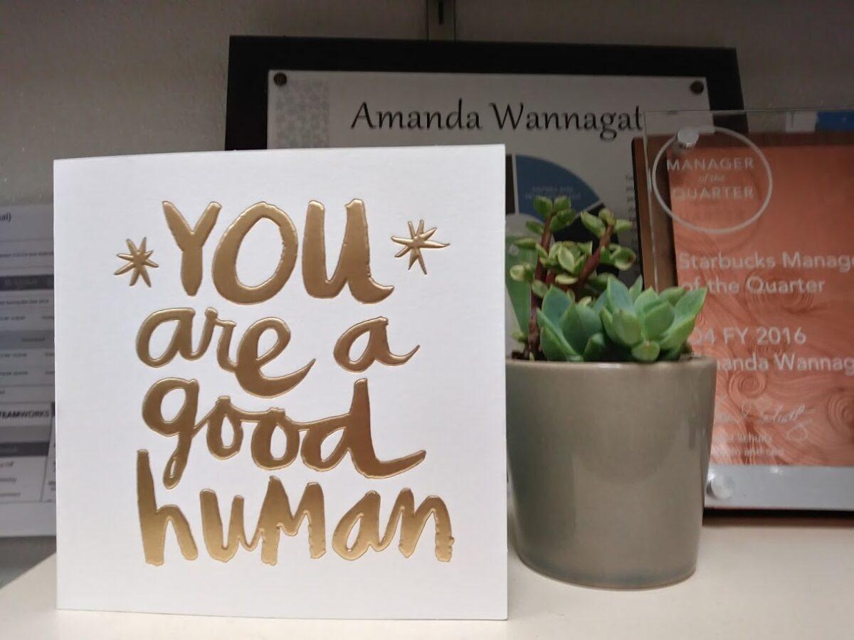An award (R) given to former Starbucks store manager Amanda Wannagat in 2016 and a card she received from her staff. (Amanda Wannagat)