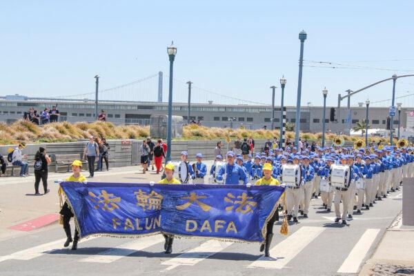 The Tian Guo Marching Band marches along the piers in San Francisco on July 17, 2021. (Cynthia Cai/The Epoch Times)