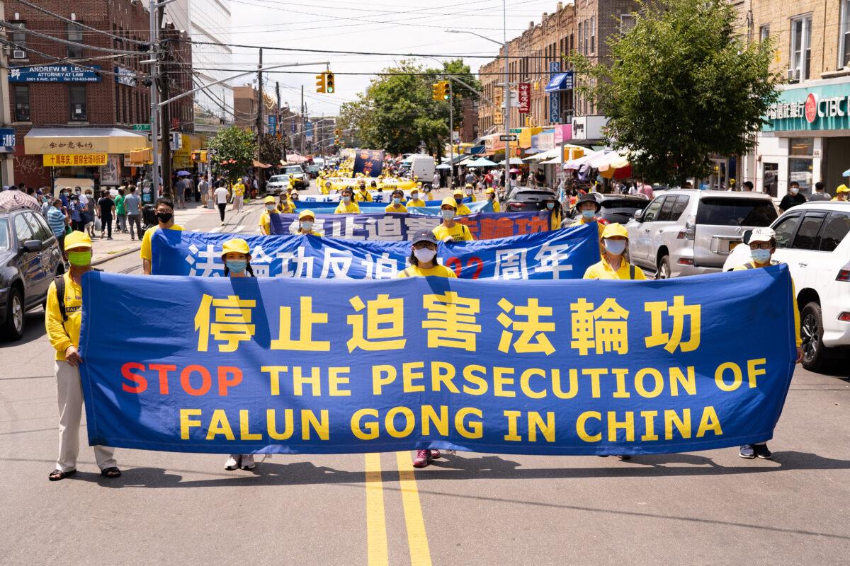 Falun Gong practitioners take part in a parade marking the 22nd year of the persecution of Falun Gong in China, in Brooklyn, N.Y., on July 18, 2021. (Larry Dye/The Epoch Times)