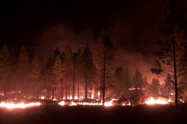 In this photo provided by the Bootleg Fire Incident Command, the Bootleg Fire burns at night near Highway 34 in southern Oregon on July 15, 2021. (Jason Pettigrew/Bootleg Fire Incident Command via AP)