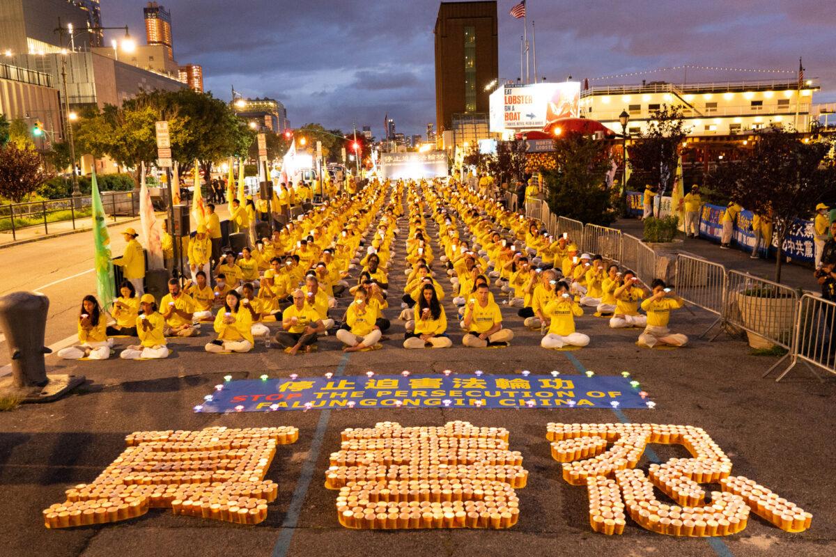 Falun Gong practitioners in a vigil commemorating the 22nd anniversary of the persecution in China, in Manhattan on July 18, 2021. The Chinese characters in front of them read "truthfulness, compassion, tolerance." (Larry Dye/The Epoch Times)