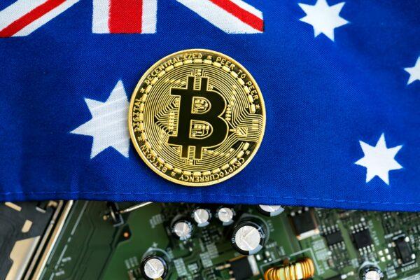 A Bitcoin cryptocurrency symbol over an Australian flag and electronic components. (Tierney / Adobe Stock)