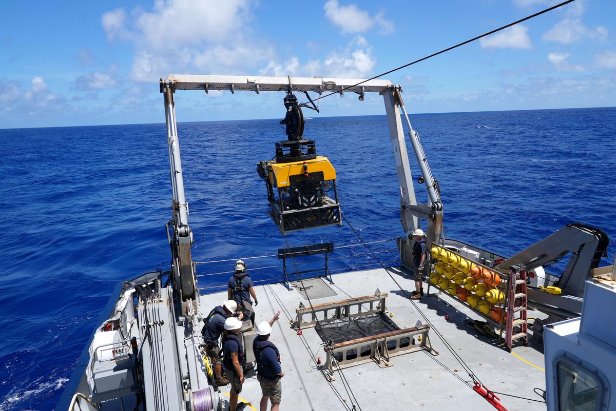 Crew members aboard the research vessel Falkor direct the first launch of the remotely operated vehicle (ROV) SuBastian during the "Discovering Deep Sea Corals of the Phoenix Islands 2" expedition. (Courtesy of <a href="https://schmidtocean.org/scientists-explore-seamounts-in-phoenix-islands-archipelago-gaining-new-insights-into-deep-water-diversity-and-ecology/">Schmidt Ocean Institute</a>)