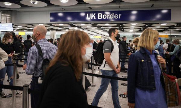 Arriving passengers queue at UK Border Control at the Terminal 5 at Heathrow Airport in London on June 29, 2021. (Hannah Mckay/Reuters)