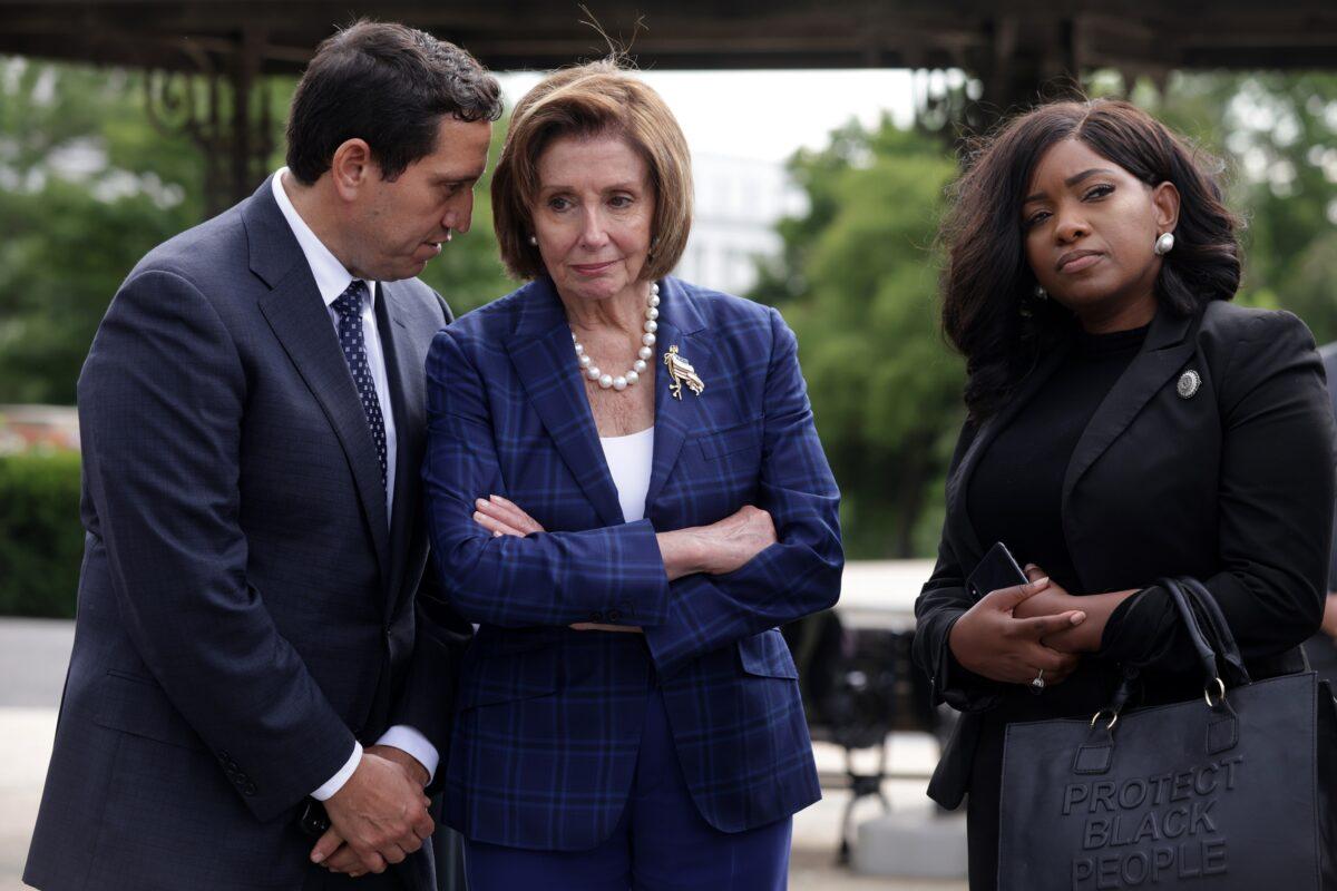 Texas Rep. Trey Martinez Fischer, one of the five Texas House Democrats who have tested positive for COVID-19, is seen on Capitol Hill with House Speaker Nancy Pelosi (D-Calif.) (C) in Washington on July 13, 2021. (Alex Wong/Getty Images)