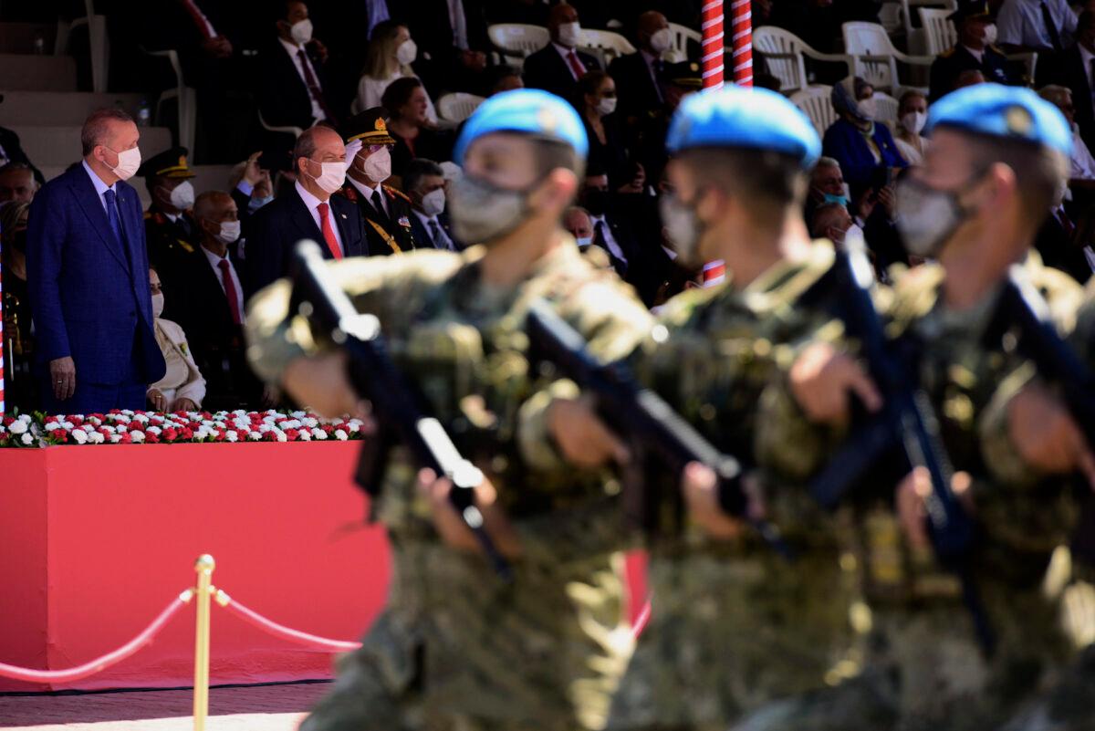 Turkish President Recep Tayyip Erdogan, back left, and Turkish Cypriot leader Ersin Tatar, second left, attend the military parade marking the 47th anniversary of the 1974 Turkish invasion in the Turkish occupied area of the divided capital Nicosia, Cyprus, on July 20, 2021. (Nedim Enginsoy/AP Photo)