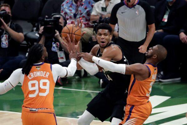 Milwaukee Bucks forward Giannis Antetokounmpo (34) is double teamed by Phoenix Suns forward Jae Crowder (99) and guard Chris Paul during the first half of Game 6 of basketball's NBA Finals in Milwaukee, Wis., on July 20, 2021. (Aaron Gash/AP Photo)