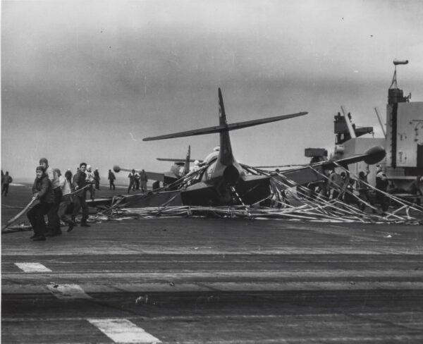 Crew members aboard the USS Bon Homme Richard rush to put out a fire and remove the pilot following an aircraft malfunction, circa 1952. (Courtesy Arthur Moss)