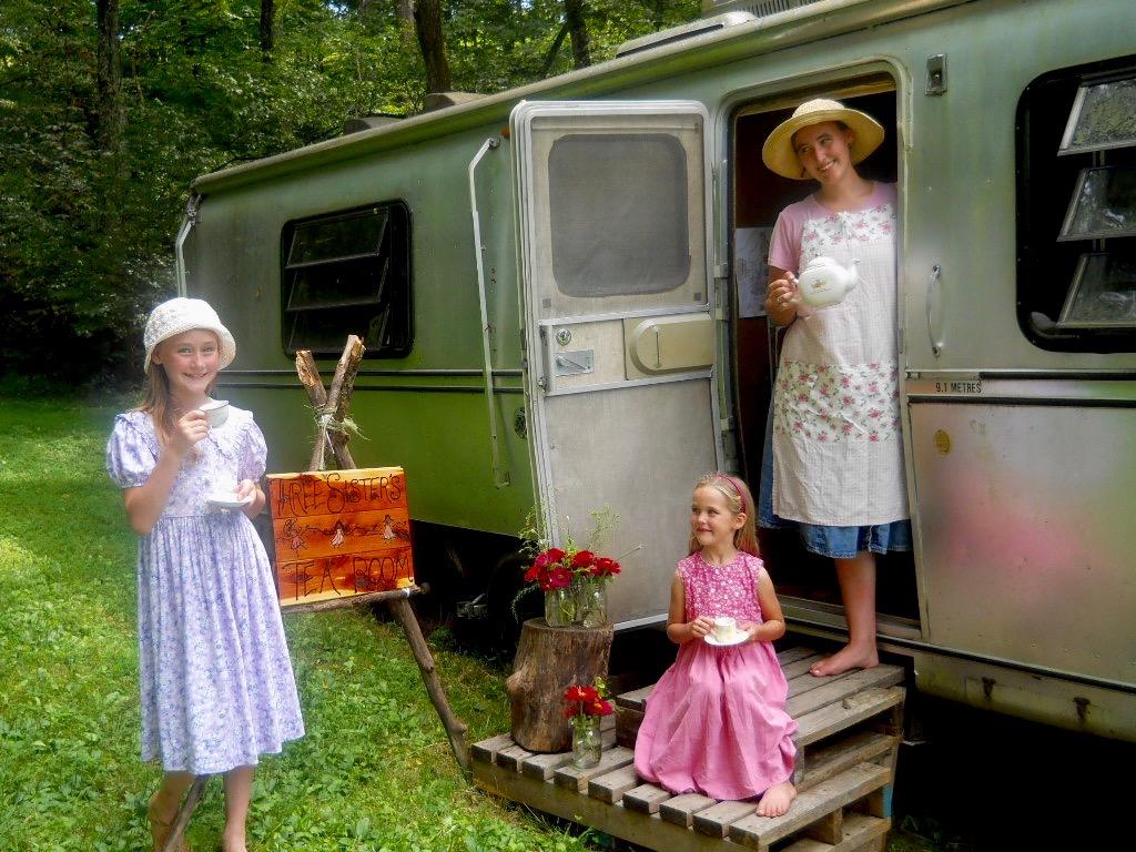 The girls enjoying a cup of tea outside their Airstream camper trailer in 2011. (Courtesy of the Stowes)