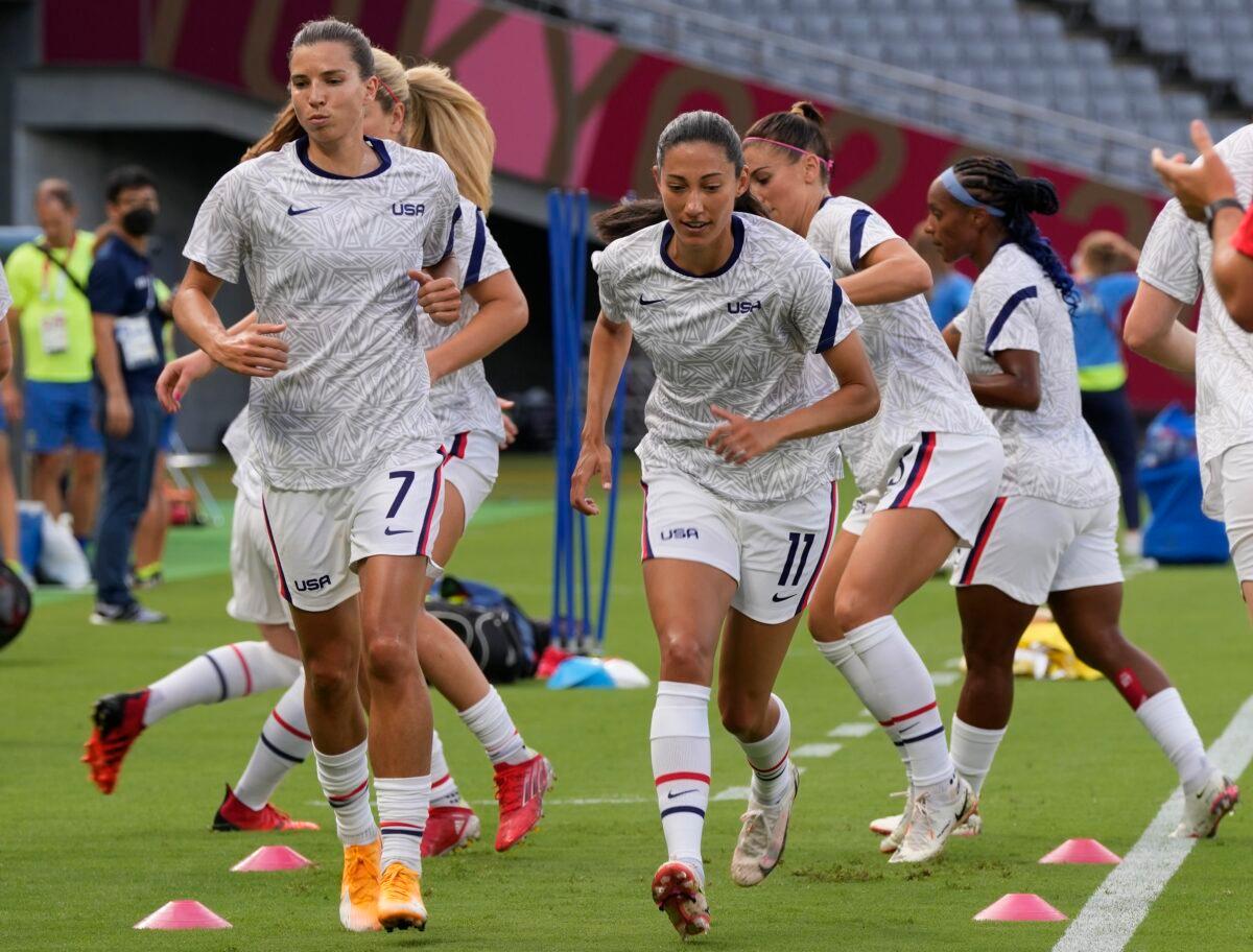United States players warm up before a women's soccer match against Sweden at the 2020 Summer Olympics in Tokyo, Japan, on July 21, 2021. (Ricardo Mazalan/AP Photo)