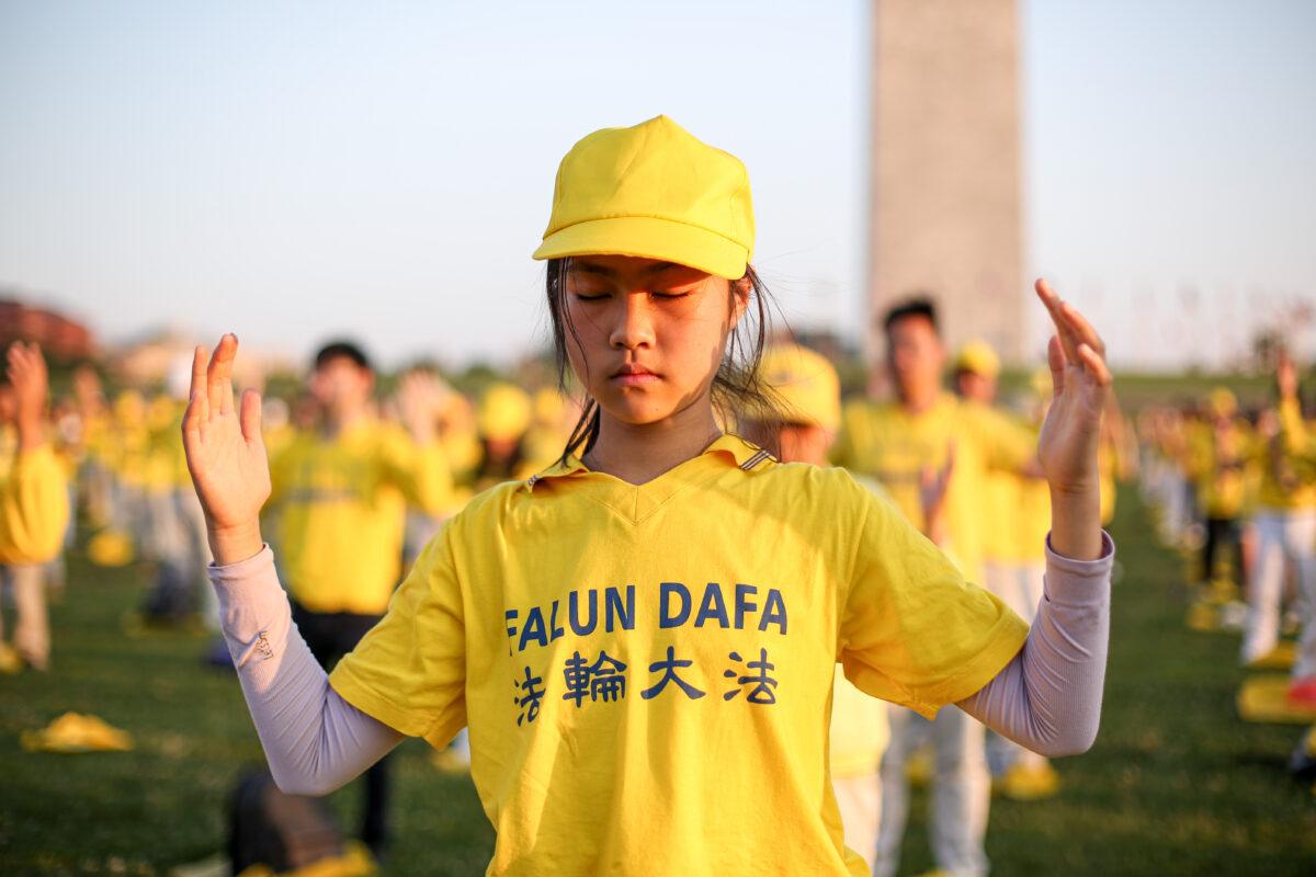Falun Gong practitioners do exercises at an event marking the 22nd anniversary of the start of the Chinese regime’s persecution of Falun Gong, in Washington on July 16, 2021. (Samira Bouaou/The Epoch Times)