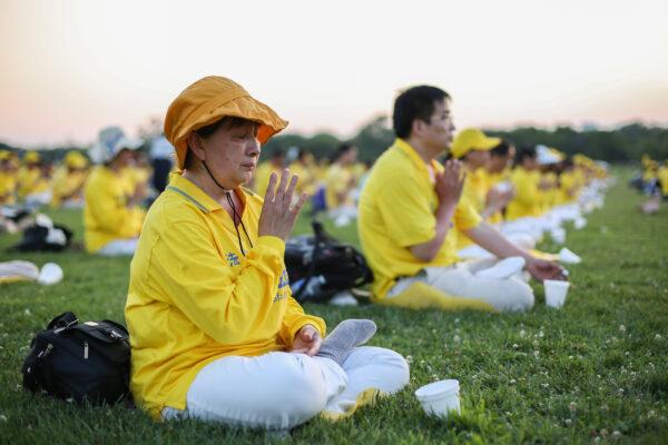 Falun Gong practitioners take part in an event marking the 22nd anniversary of the start of the Chinese regime’s persecution of Falun Gong in Washington on July 16, 2021. (Samira Bouaou/The Epoch Times)