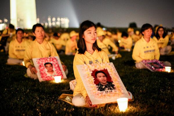 Falun Gong practitioners take part in a candlelight vigil remembering victims of the 22-year-long persecution in China at the Washington Monument, on July 16, 2021. (Samira Bouaou/The Epoch Times).