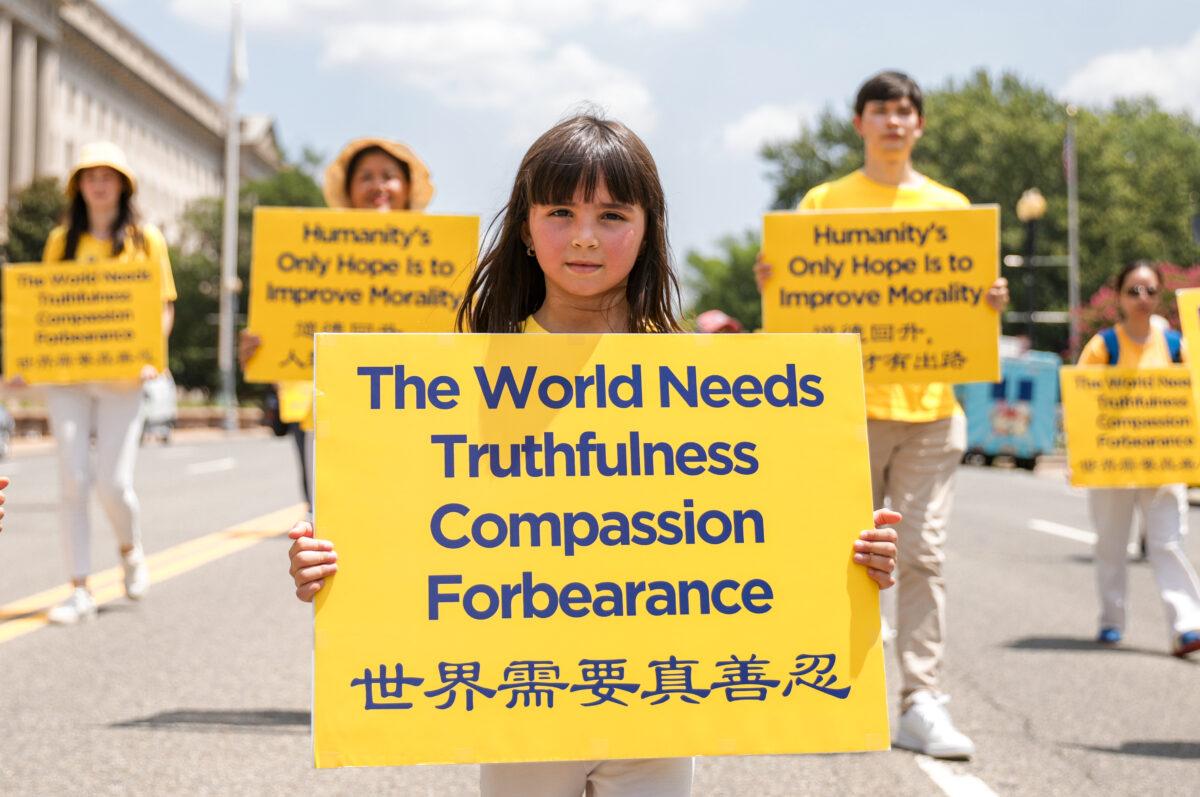 Falun Gong practitioners take part in a parade marking the 22nd anniversary of the start of the Chinese regime’s persecution of Falun Gong, in Washington on July 16, 2021. (Samira Bouaou/The Epoch Times)